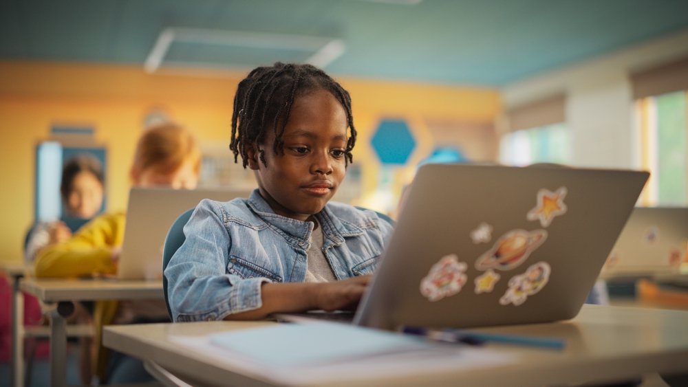 Talented,Small,African,American,Boy,Using,A,Laptop,Computer,In